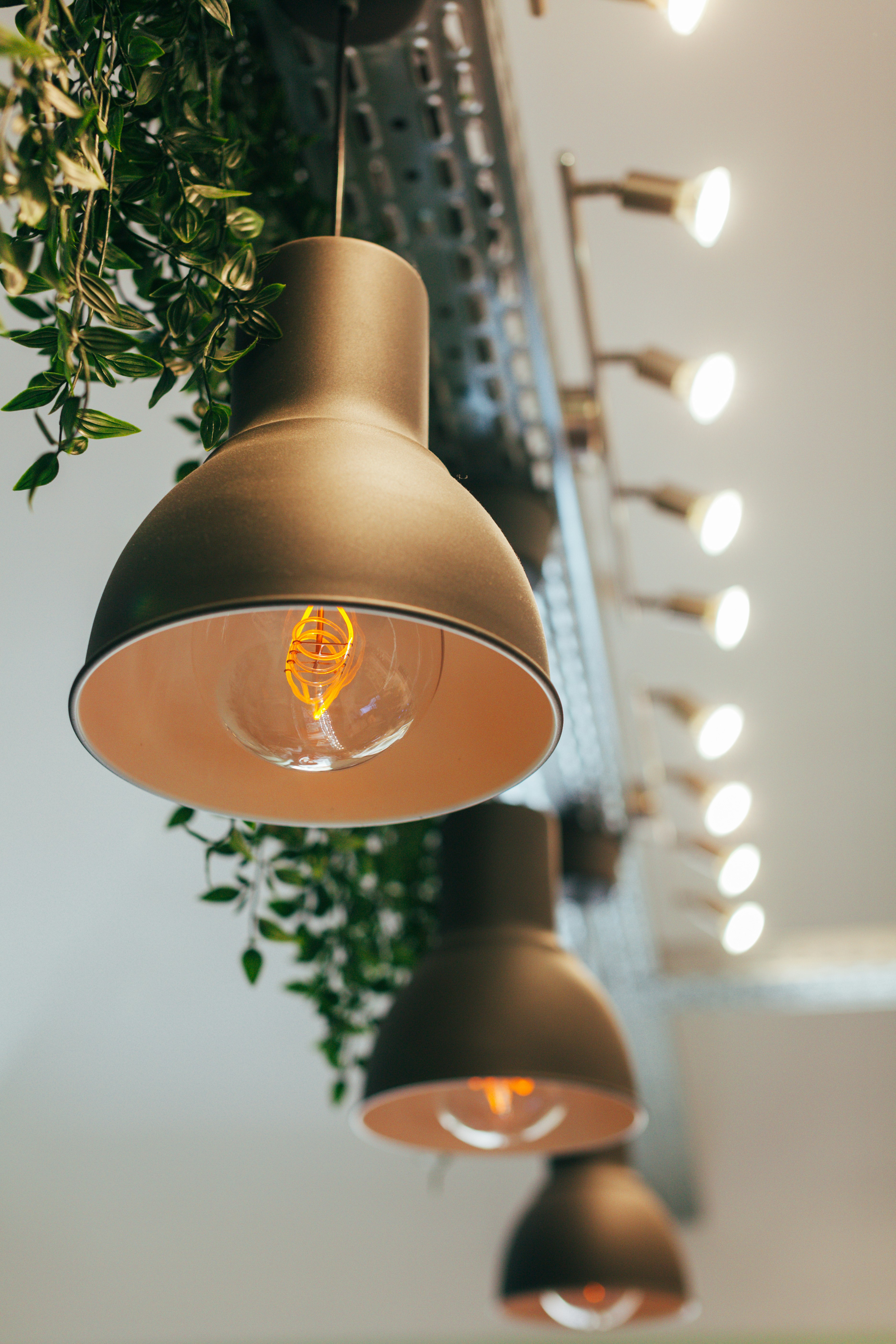 gray pendant lamp beside vanity lamp